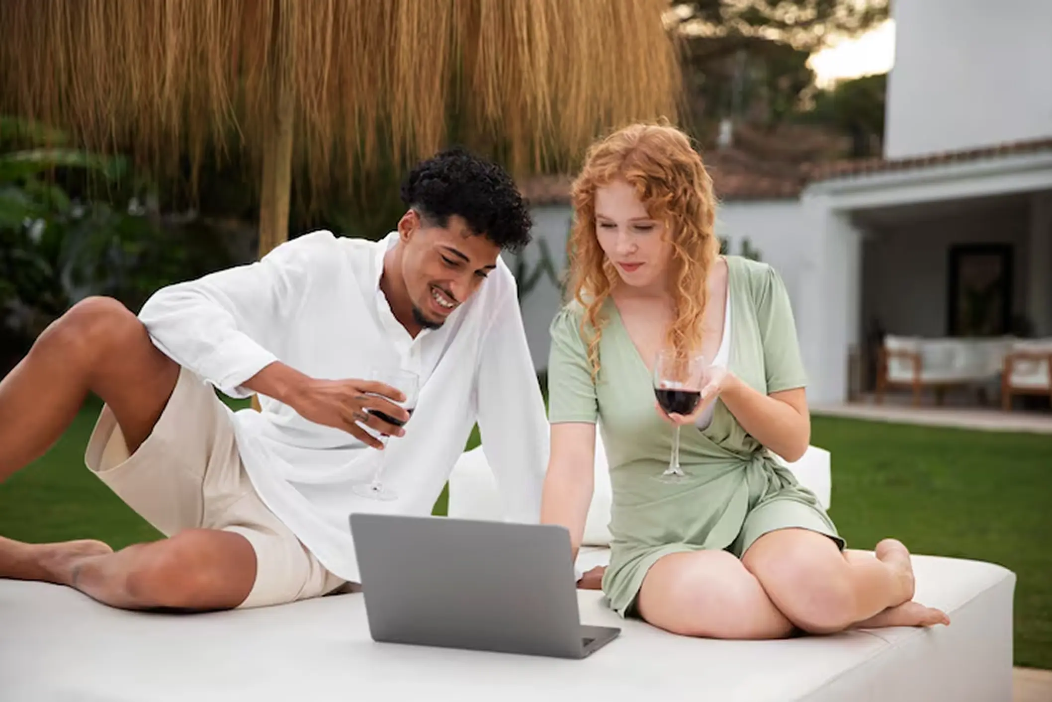 Couple using laptop outdoors